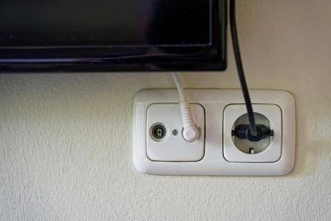 Wall mounted screen with connected cables and tidy yellow room Stock Photos