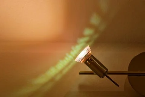 Wall mounted side lamp casting warm fanlike light rays Stock Photos