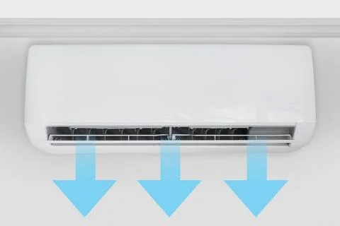 Wall-mounted split air conditioner in a room with cool air flow shown by arrows Stock Photos