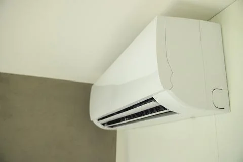 Wall-mounted split air conditioner in a modern interior, designed for cooling Stock Photos