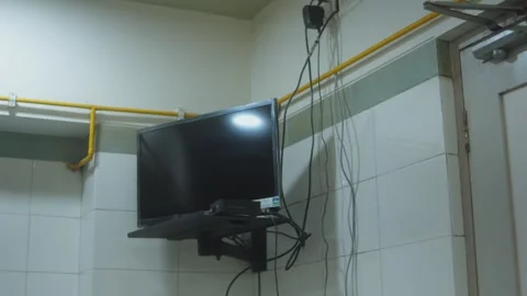 Wall-mounted TV in tiled room Stock Footage 305017493