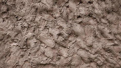 A wall of mud, cement putty decorative background, a mixture of earth smeared on Stock Photos