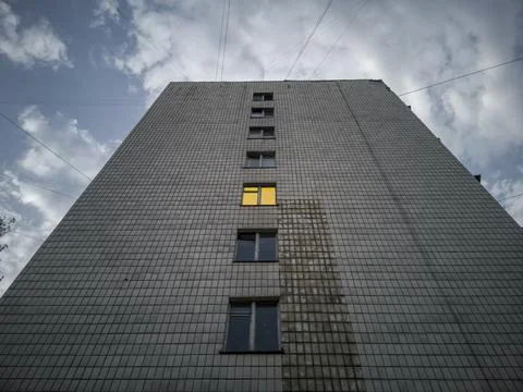 The wall of a multi-storey post-Soviet apartment building with a vertical row Stock Photos