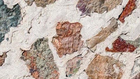 Wall of multicolored stones of different shapes embedded in cement mortar, .. 스톡 동영상 256325047