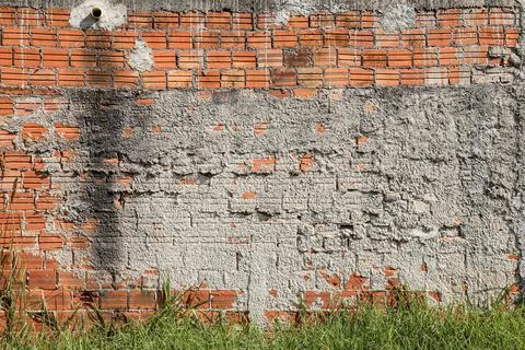 Wall mute with plaster and some exposed bricks Stock Photos