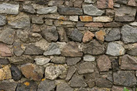 The wall of natural stone raw. Creative vintage natural brown background. Stock Photos