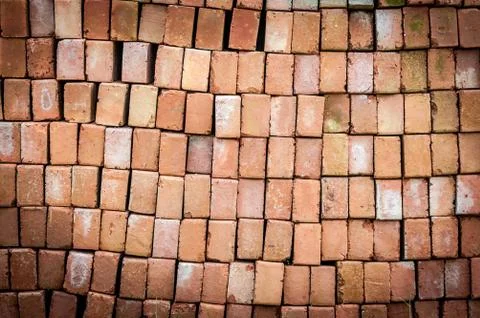 Wall of new red bricks stacked in rows. Stock Photos