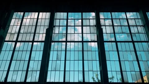 Wall of an old abandoned factory with large broken windows and wooden barriers Stock Footage 261760060