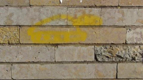 Wall of old and gray bricks in daylight Stock Photos