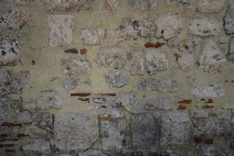 Wall from an old block made of shell rock and red brick background. Stock Photos