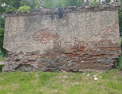 The wall of an old brick building with plaster that collapses Stock Photos