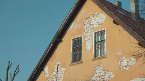 The wall of an old brick house with two windows and broken plaster Stock Footage 149306310