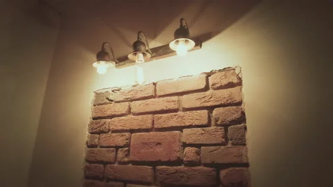 A wall with old bricks in it, illuminated by lamps, camera movement, close-up Stock Footage 155462562