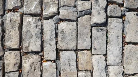 A Wall of old, cracked bricks or stones, with a Weathered Surface. Aged Bri.. Stock Photos
