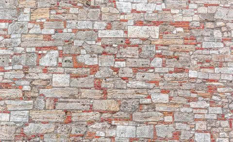 Wall from old gray bricks and stone as an abstract background Foto stock