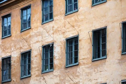 Wall of old house with windows Stock Photos