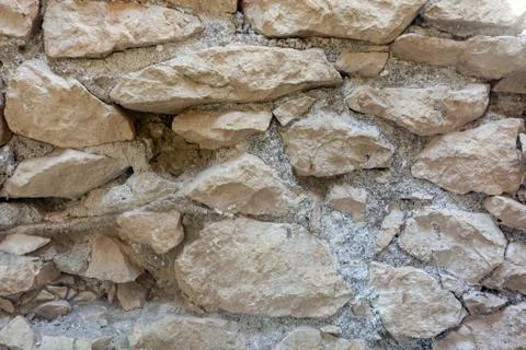 A wall of old light stone Stock Photos
