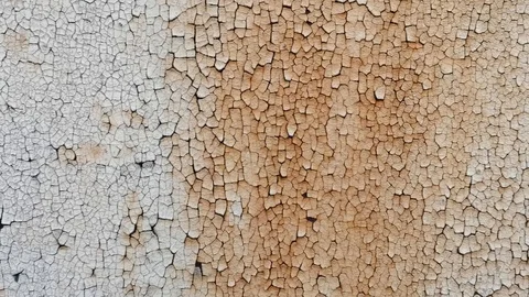 A wall with old paint that POPs off the surface and bursts Stock Footage 120441137