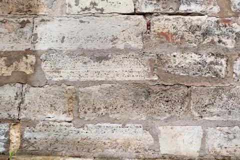 Wall of old sandstone blocks. Background texture. Stock Photos
