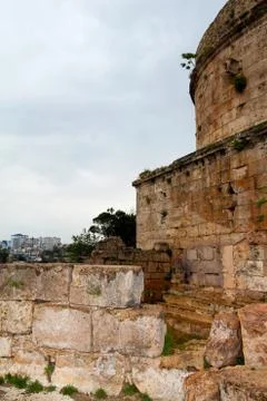 The wall of the old tower. The brick collapsed the fence. Antalya, Turkey. Stock Photos