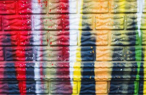Wall painted with bright colors as a texture. Abstract drawings on the wall. Stock Photos