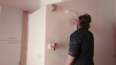 Wall painter working in a building site with mask Stock Footage 130440980