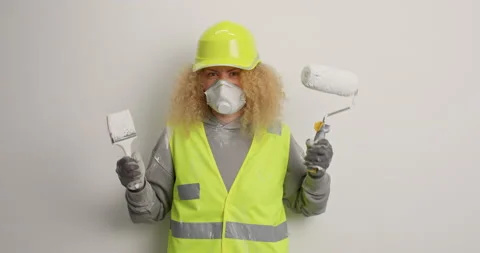 Wall painting repair and restructuring process. Annoyed curly haired woman wears Stock Footage 155487166
