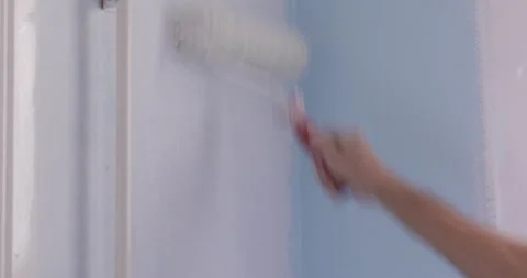 Wall painting using paint roller Stock Footage 321470597