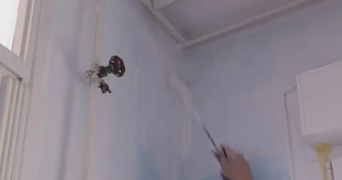 Wall painting using paint roller Stock Footage 321470826
