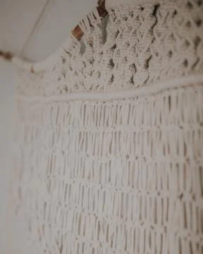 Wall panel in Boho style made of cotton threads in natural white color using  Stock Photos