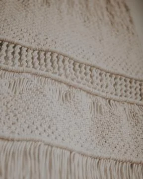 Wall panel in Boho style made of cotton threads in natural white color using  Stock Photos