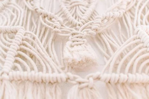 Wall panel in boho style made of cotton threads of natural color Stock Photos