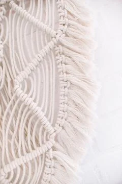 Wall panel in boho style made of cotton threads of natural color Stock Photos