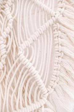 Wall panel in boho style made of cotton threads of natural color Stock Photos