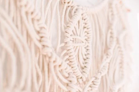 Wall panel in boho style made of cotton threads of natural color Stock Photos