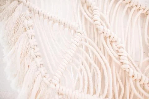 Wall panel in boho style made of cotton threads of natural color Stock Photos