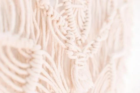 Wall panel in boho style made of cotton threads of natural color Stock Photos