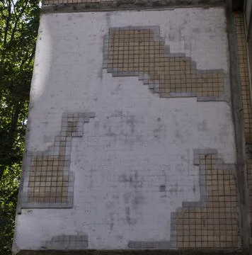 Wall panel house, covered with small mosaic tiles. Old concrete wall with mos Stock Photos