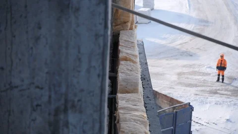 Wall panel lifted by crane approaches monolithic building Stock Footage 125930451