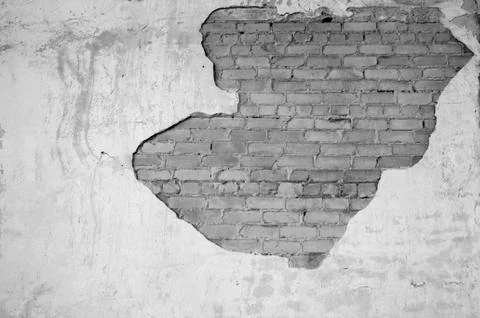 Wall with partially removed plaster in the form of figured drawing of a brick Stock Photos