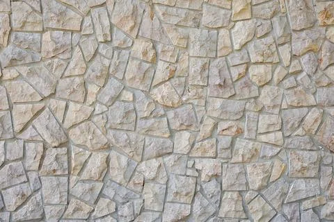 Wall with a pattern of decorative irregular gray stones Stock Photos