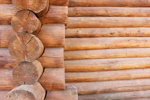 Wall of pine logs. Texture of a horizontal wooden wall. Wood wall texture for Stock Photos
