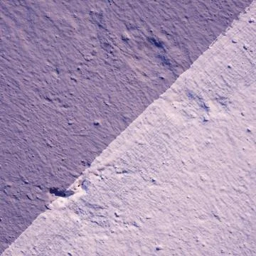 A wall with a plaster texture, painted in two colors. Stock Photos