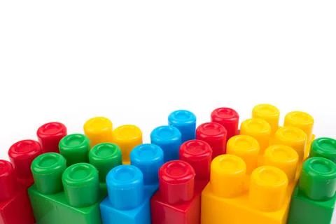 Wall from Plastic building blocks isolated on white background. Top view with Stock Photos