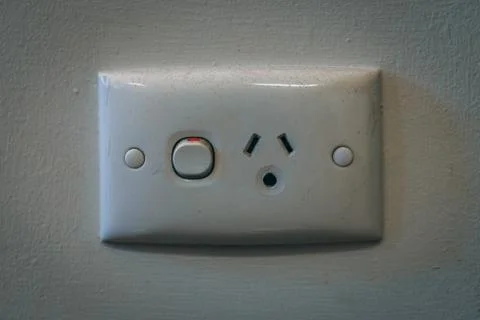 Wall power outlet with switch painted white 스톡 사진