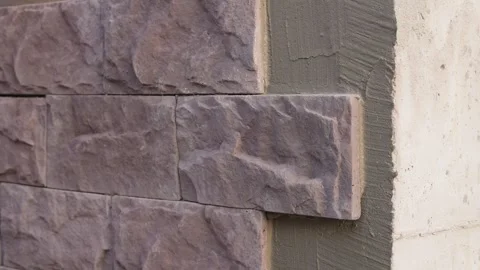 Wall prepared for decorative stone cladding the first tiles already installed. Video stock 318471237