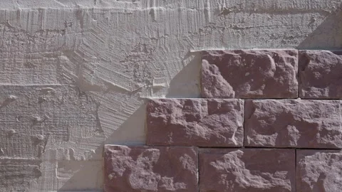 Wall prepared for decorative stone cladding the first tiles already installed. Video stock 318471285