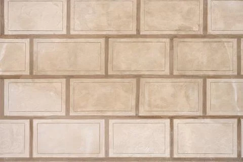Wall with rectangular beige stone slabs Stock Photos