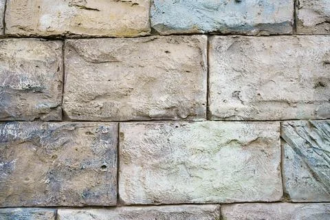 Wall of rectangular stone bricks. background and texture of cobblestones. Stock Photos