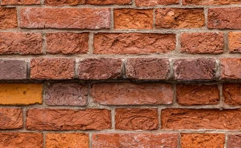 A wall of red bricks abstract background. Texture of bricks. Stock Photos